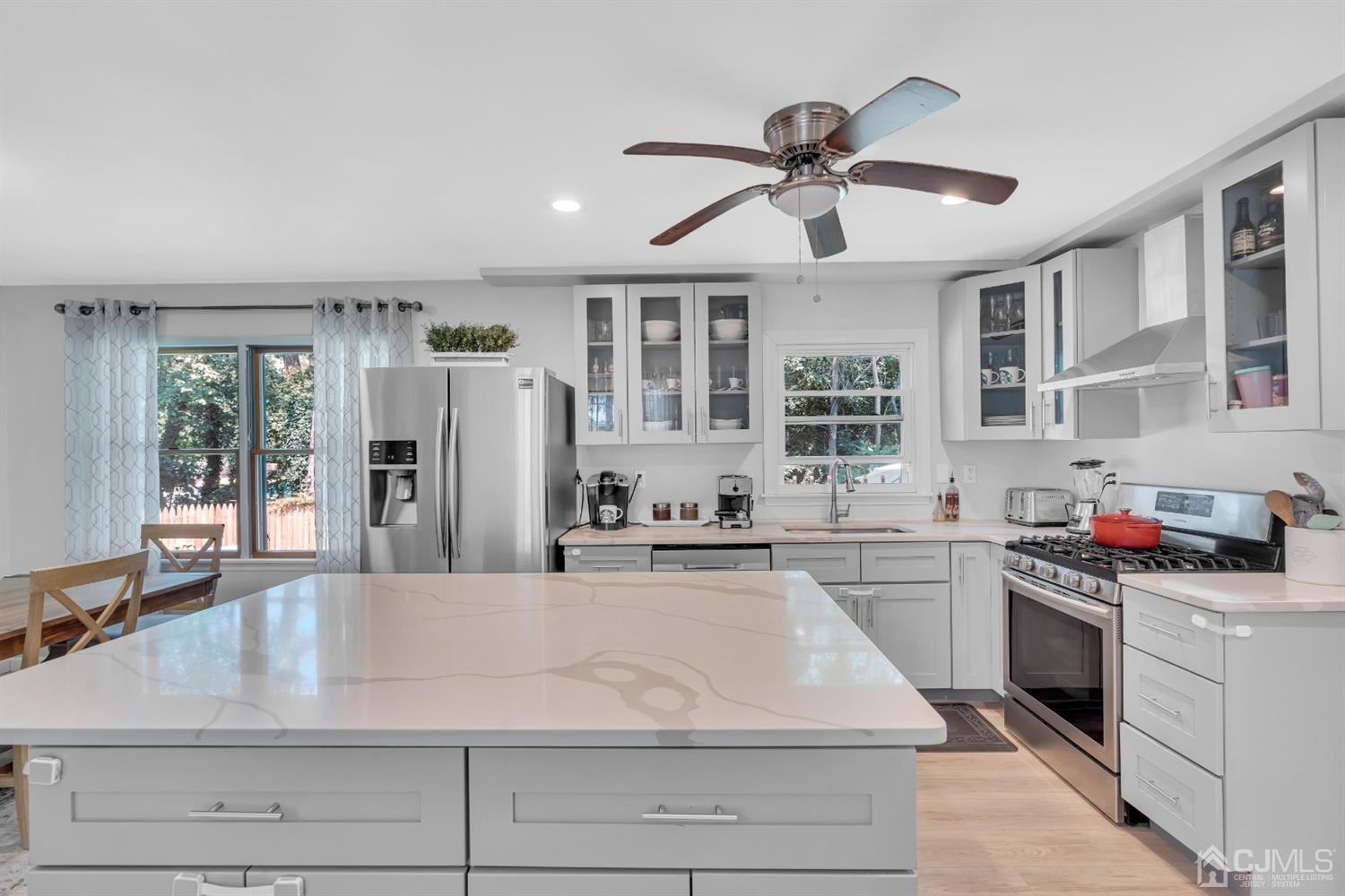 76 Bethany Road Hazlet, NJ 07730 - Photo 15 of 33 a kitchen with stainless steel appliances granite countertop a stove and a sink