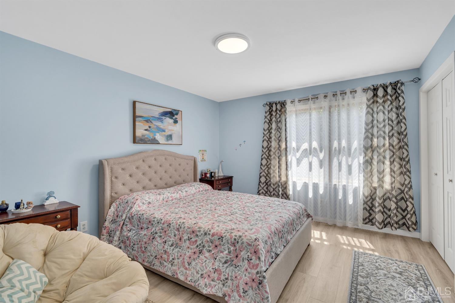 76 Bethany Road Hazlet, NJ 07730 - Photo 19 of 33 a bedroom with a large bed and a couch