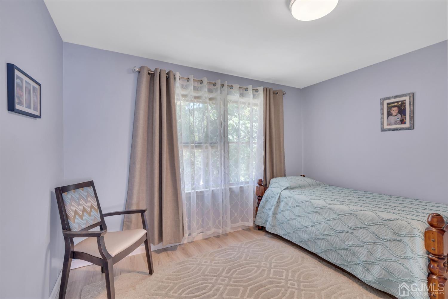 76 Bethany Road Hazlet, NJ 07730 - Photo 21 of 33 a bedroom with a bed and chair