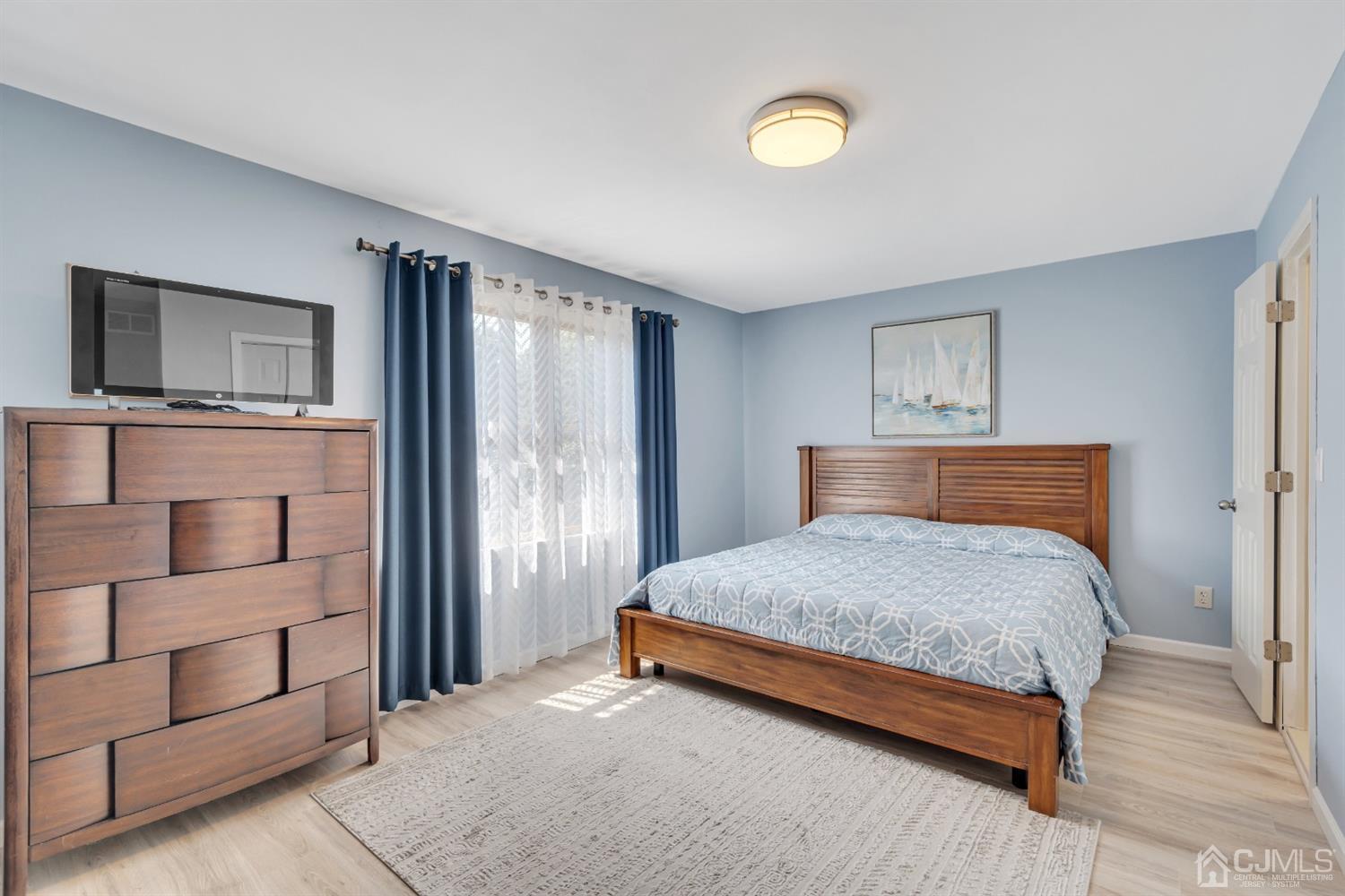 76 Bethany Road Hazlet, NJ 07730 - Photo 23 of 33 a bedroom with a bed closet and flat tv screen