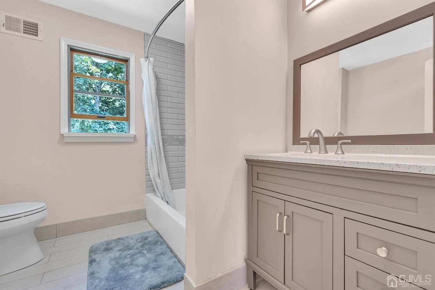 76 Bethany Road Hazlet, NJ 07730 - Photo 26 of 33 a bathroom with a sink a toilet and a mirror