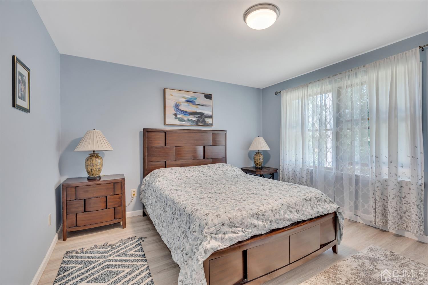 76 Bethany Road Hazlet, NJ 07730 - Photo 27 of 33 a bedroom with a bed and a painting on the wall