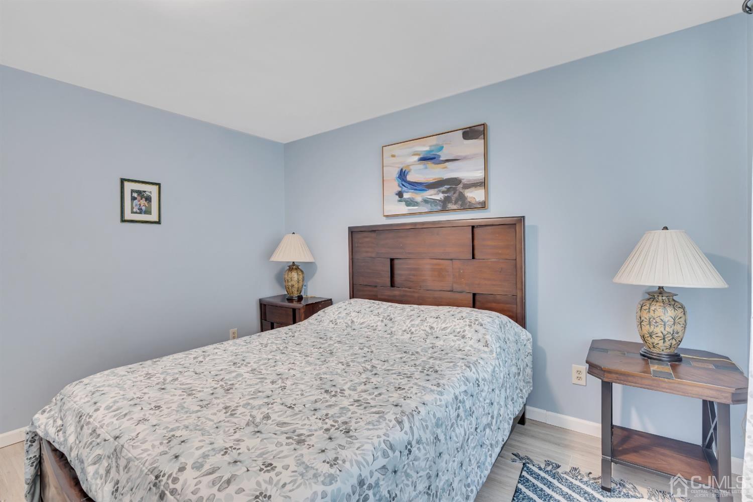 76 Bethany Road Hazlet, NJ 07730 - Photo 28 of 33 a bedroom with a bed and a lamp on table