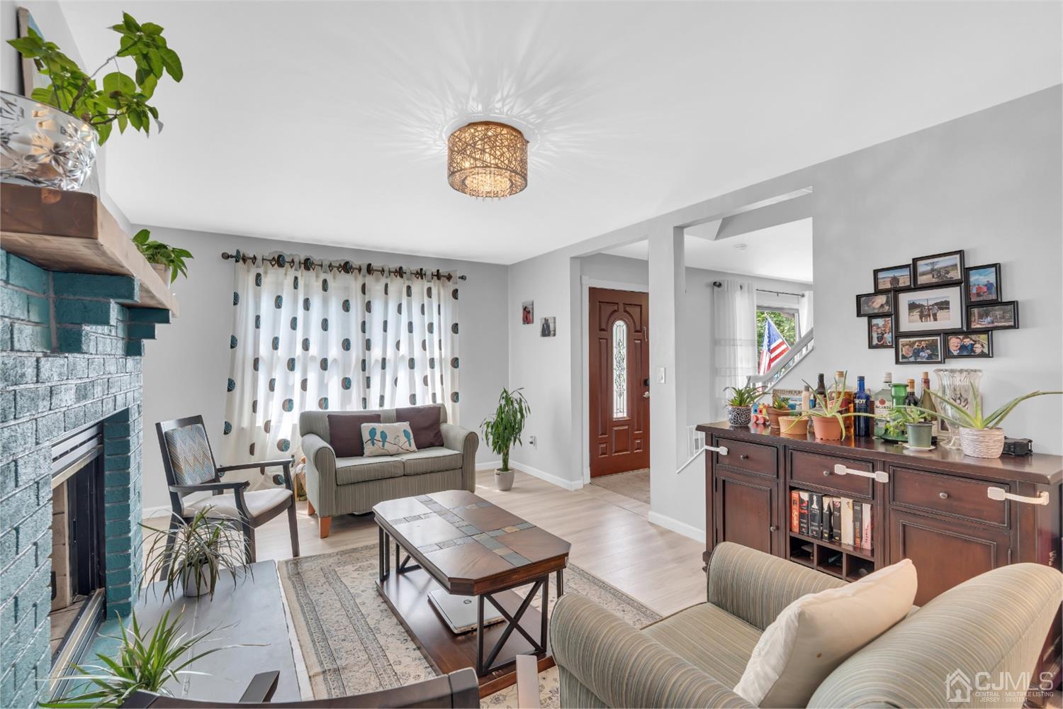 76 Bethany Road Hazlet, NJ 07730 - Photo 5 of 33 a living room with furniture and a fireplace