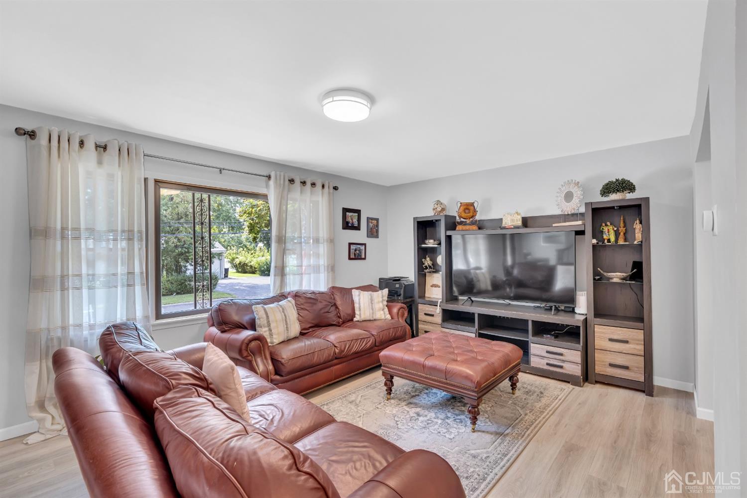 76 Bethany Road Hazlet, NJ 07730 - Photo 10 of 33 a living room with furniture and a flat screen tv