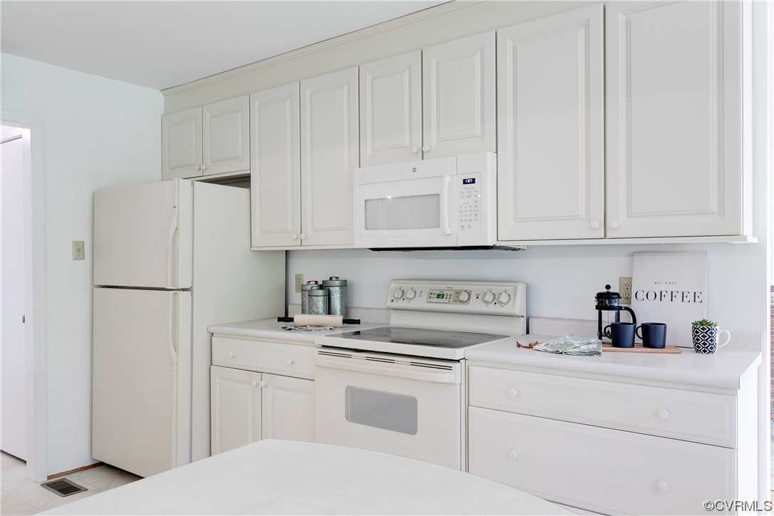 4000 Cheyenne Road Richmond, VA 23235 - Photo 15 of 50 a kitchen with stainless steel appliances white cabinets and a refrigerator