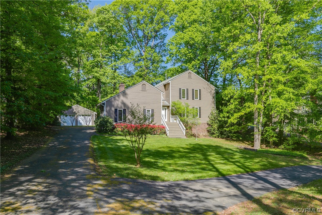4000 Cheyenne Road Richmond, VA 23235 - Photo 2 of 50 a front view of house with a garden and trees