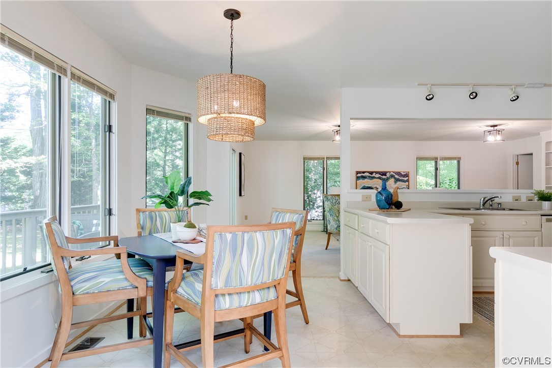 4000 Cheyenne Road Richmond, VA 23235 - Photo 10 of 50 a kitchen with kitchen island a dining table and a chandelier