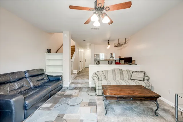 a living room with furniture and kitchen view