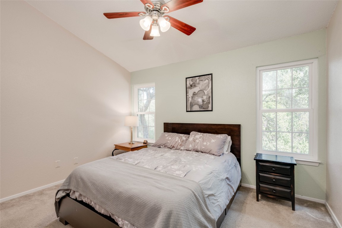 11821 Bittern Hollow, Unit 34 Austin, TX 78758 - Photo 3 of 24 Carpeted bedroom featuring lofted ceiling and a ceiling fan