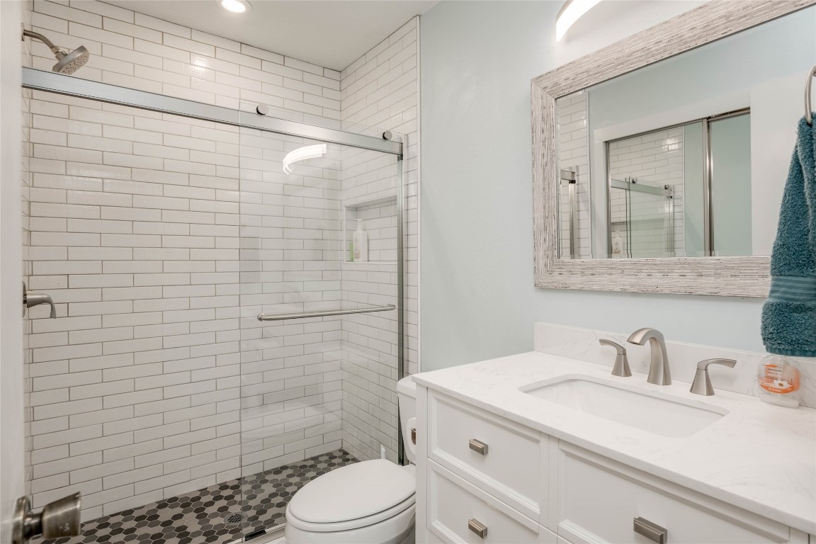 11821 Bittern Hollow, Unit 34 Austin, TX 78758 - Photo 5 of 24 Bathroom with vanity, a shower stall, and recessed lighting