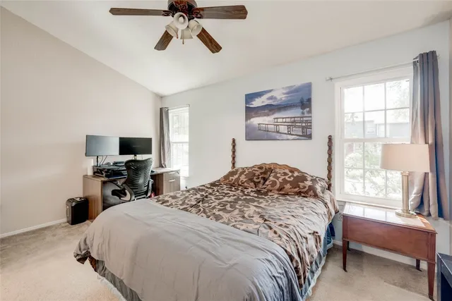 a bedroom with a bed and a tv on the dresser