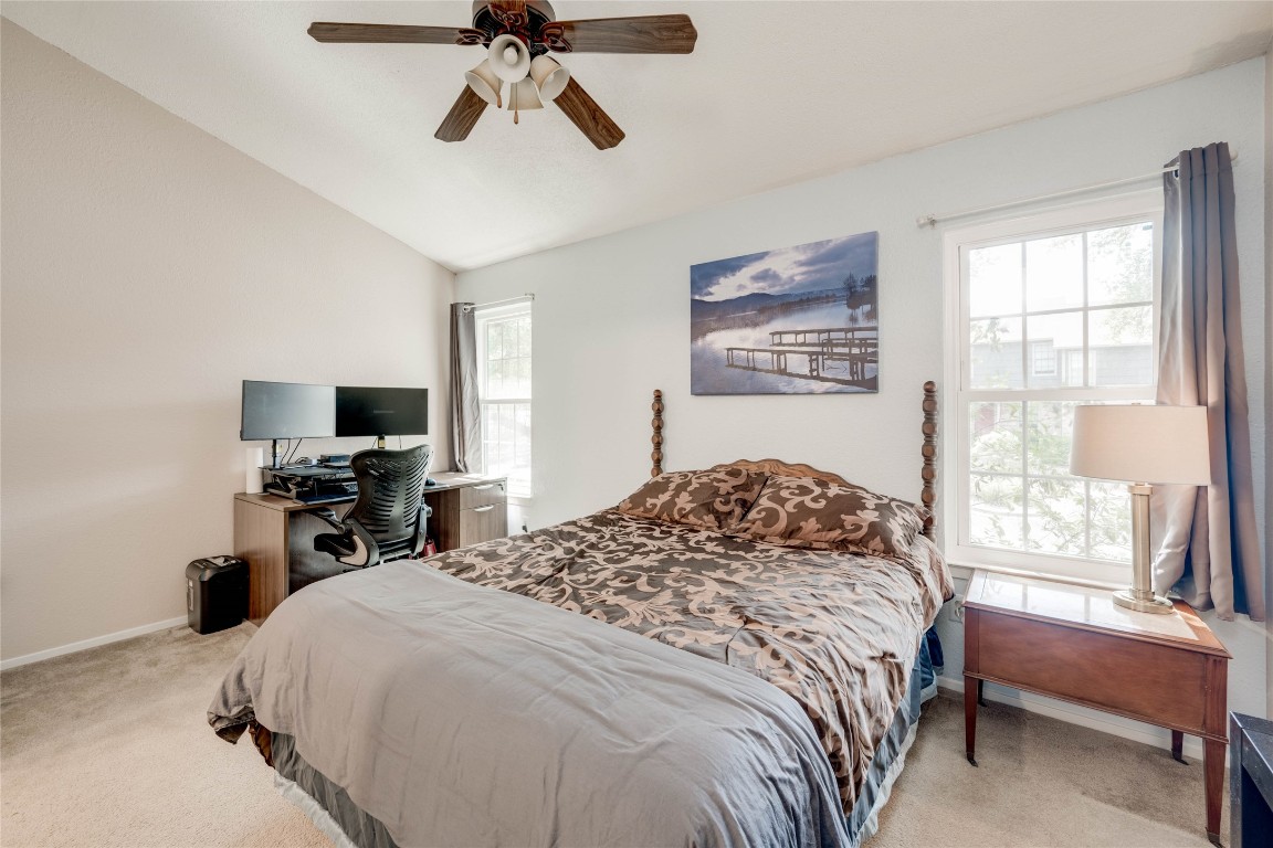 11821 Bittern Hollow, Unit 34 Austin, TX 78758 - Photo 8 of 24 Bedroom with light carpet, vaulted ceiling, and ceiling fan