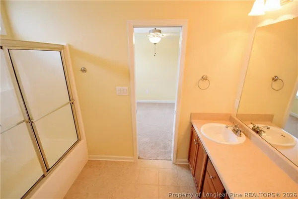 a bathroom with a sink a mirror and shower
