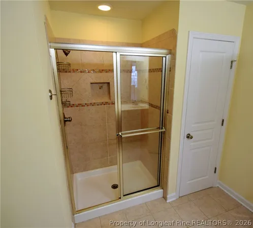 a bathroom with a glass shower door