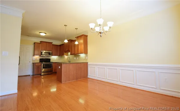a large kitchen with kitchen island a sink stainless steel appliances and cabinets