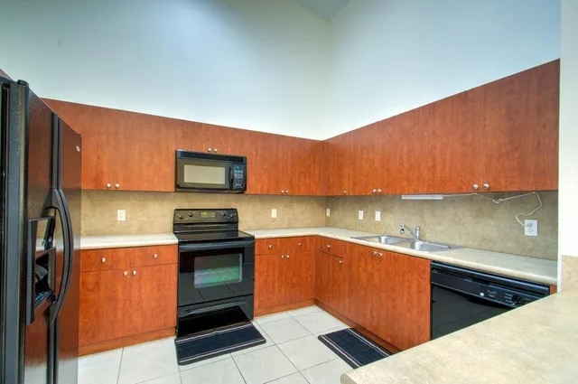 a kitchen with stainless steel appliances granite countertop a stove and a refrigerator