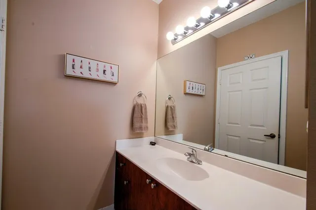 a bathroom with a sink vanity and a mirror