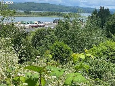 an aerial view of a house with a yard and lake view