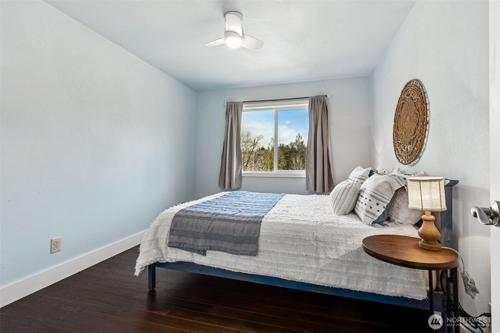 6103 Lackey Road Northwest Vaughn, WA 98394 - Photo 14 of 37 a bedroom with a bed and a chandelier