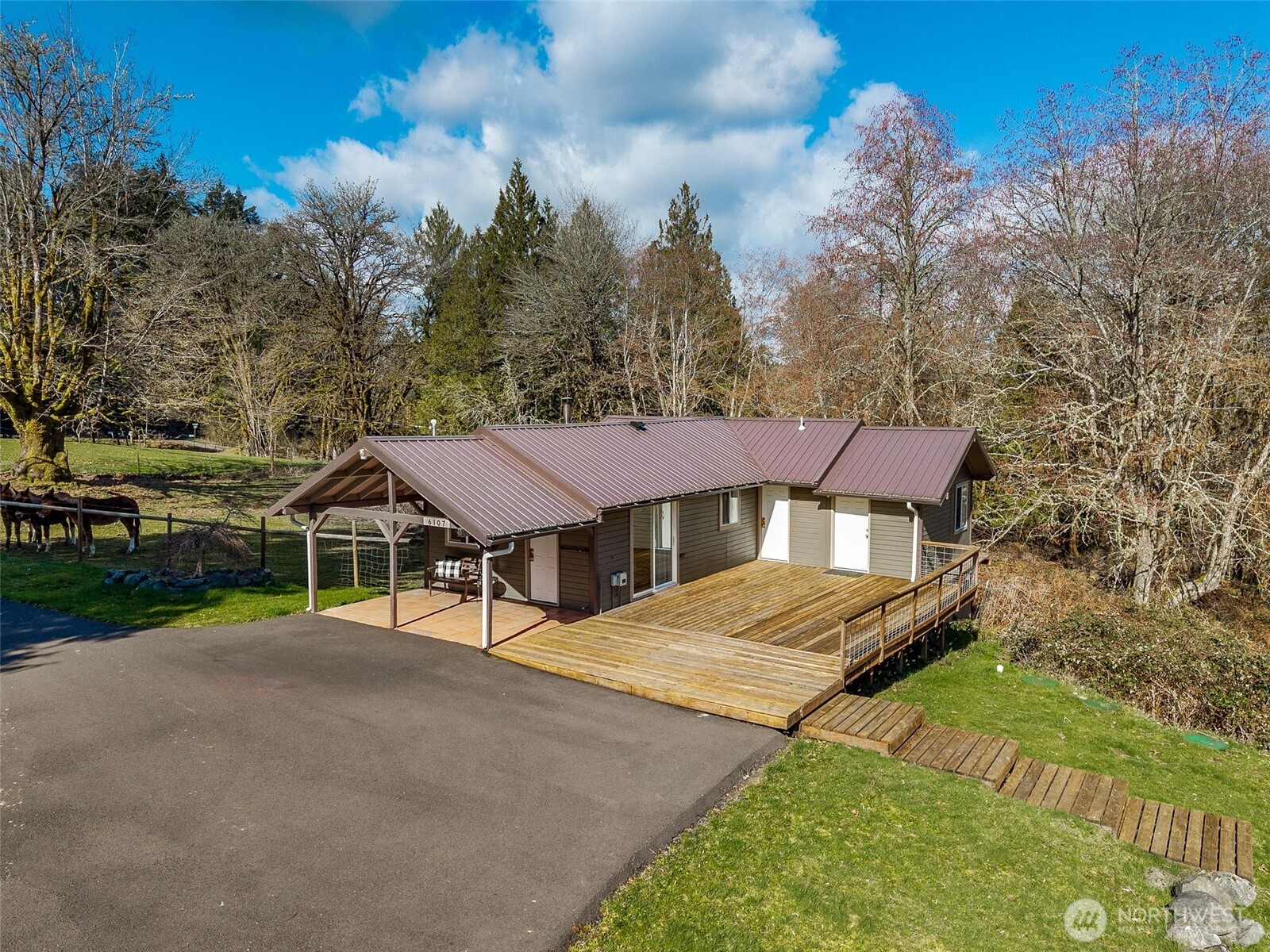 6103 Lackey Road Northwest Vaughn, WA 98394 - Photo 19 of 37 a view of a house with a yard and sitting area