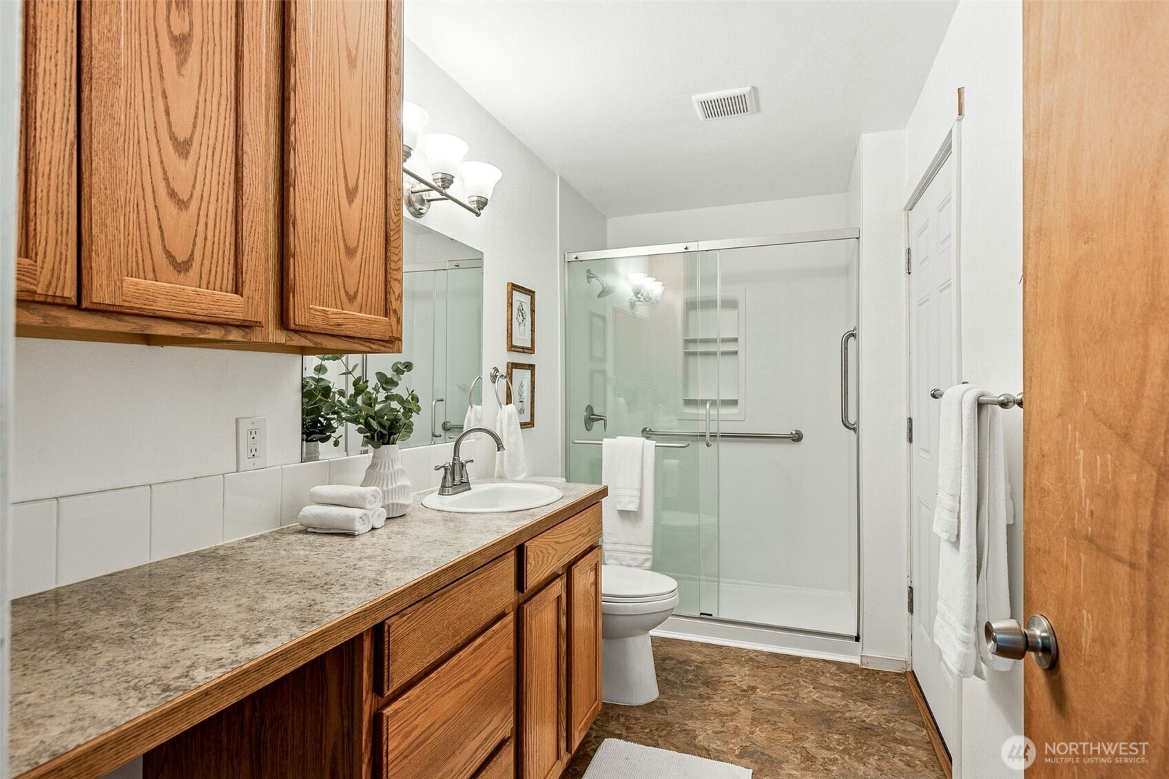 6103 Lackey Road Northwest Vaughn, WA 98394 - Photo 24 of 37 a bathroom with a granite countertop sink a toilet and shower
