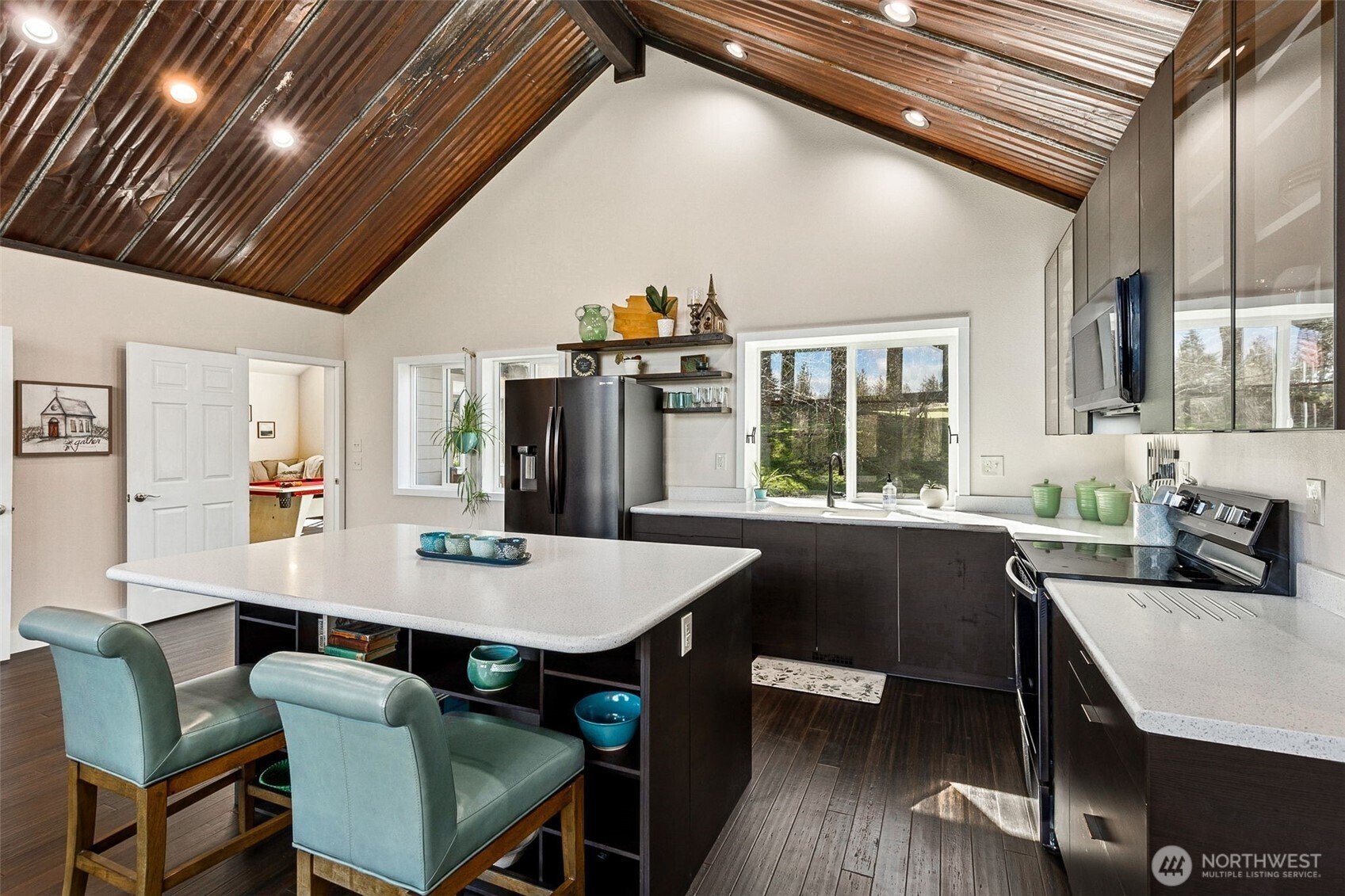 6103 Lackey Road Northwest Vaughn, WA 98394 - Photo 3 of 37 a view of a dining room with furniture window and wooden floor