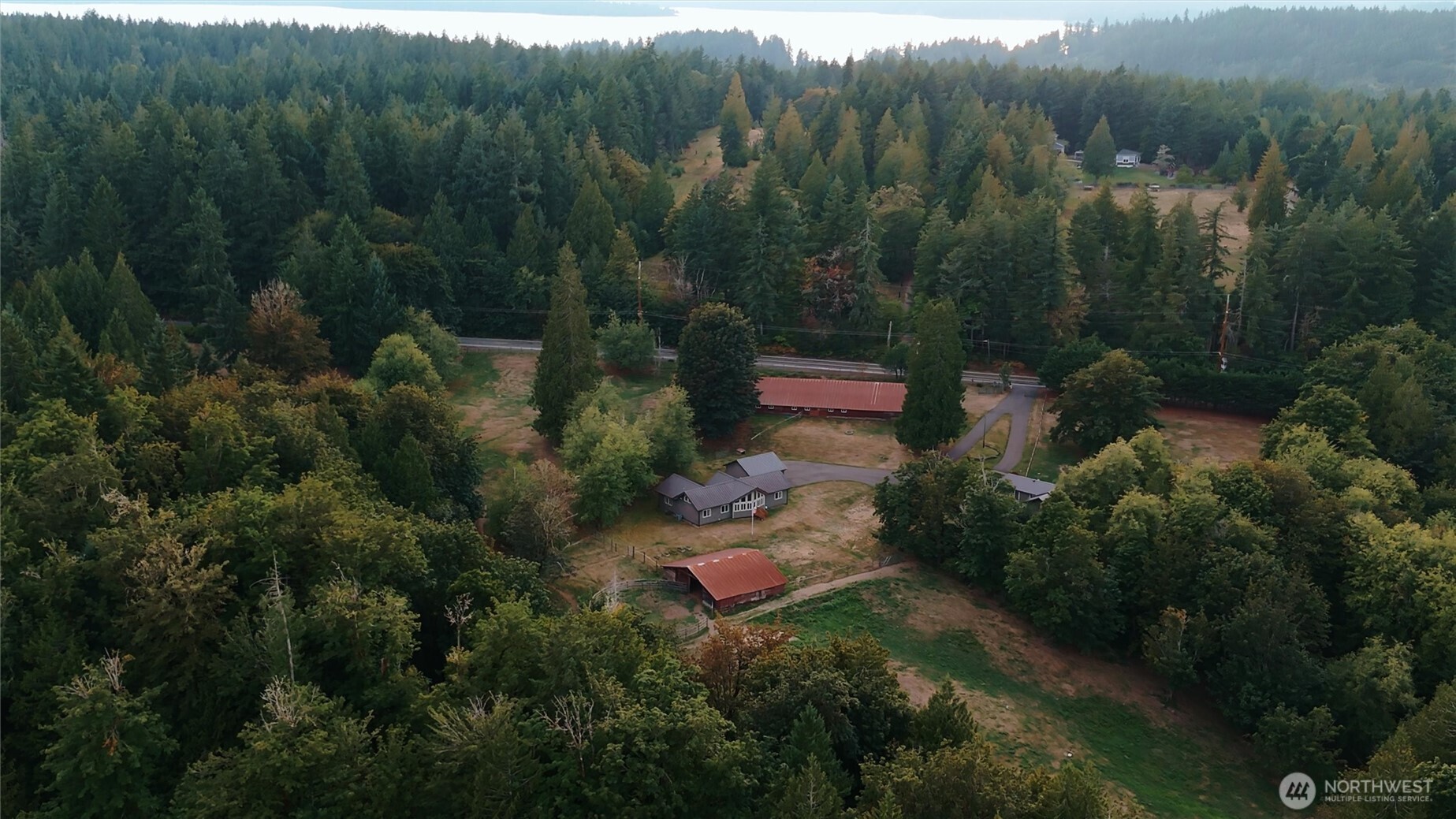 6103 Lackey Road Northwest Vaughn, WA 98394 - Photo 35 of 37 a aerial view of a house with lots of trees
