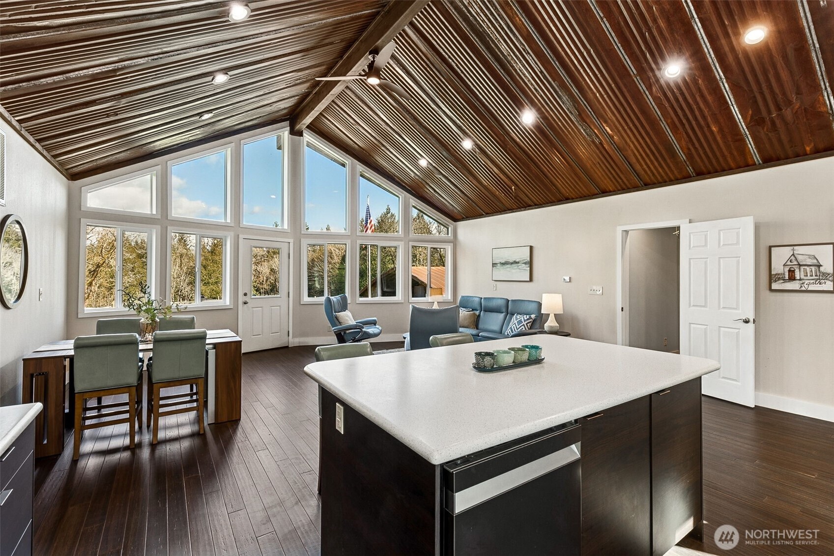 6103 Lackey Road Northwest Vaughn, WA 98394 - Photo 4 of 37 a open kitchen with stainless steel appliances granite countertop a dining table chairs and wooden floor
