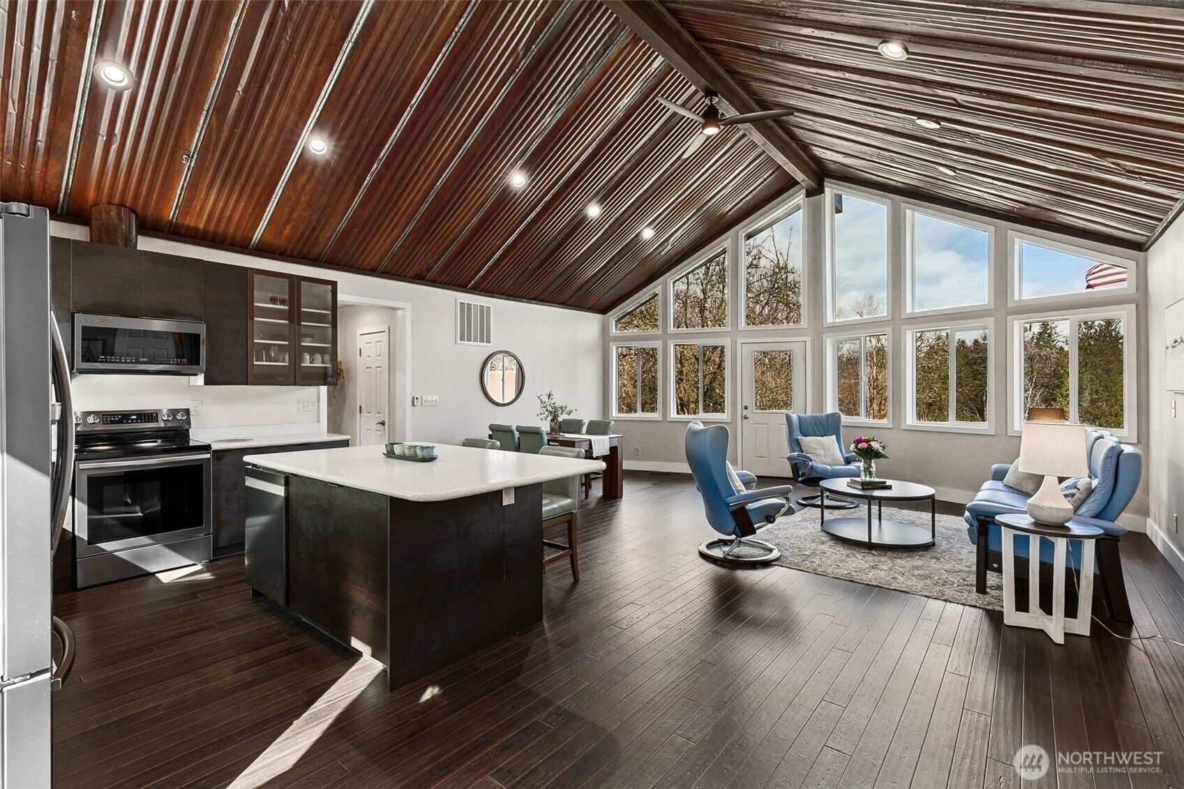 6103 Lackey Road Northwest Vaughn, WA 98394 - Photo 5 of 37 a view of a dining room with furniture window and wooden floor