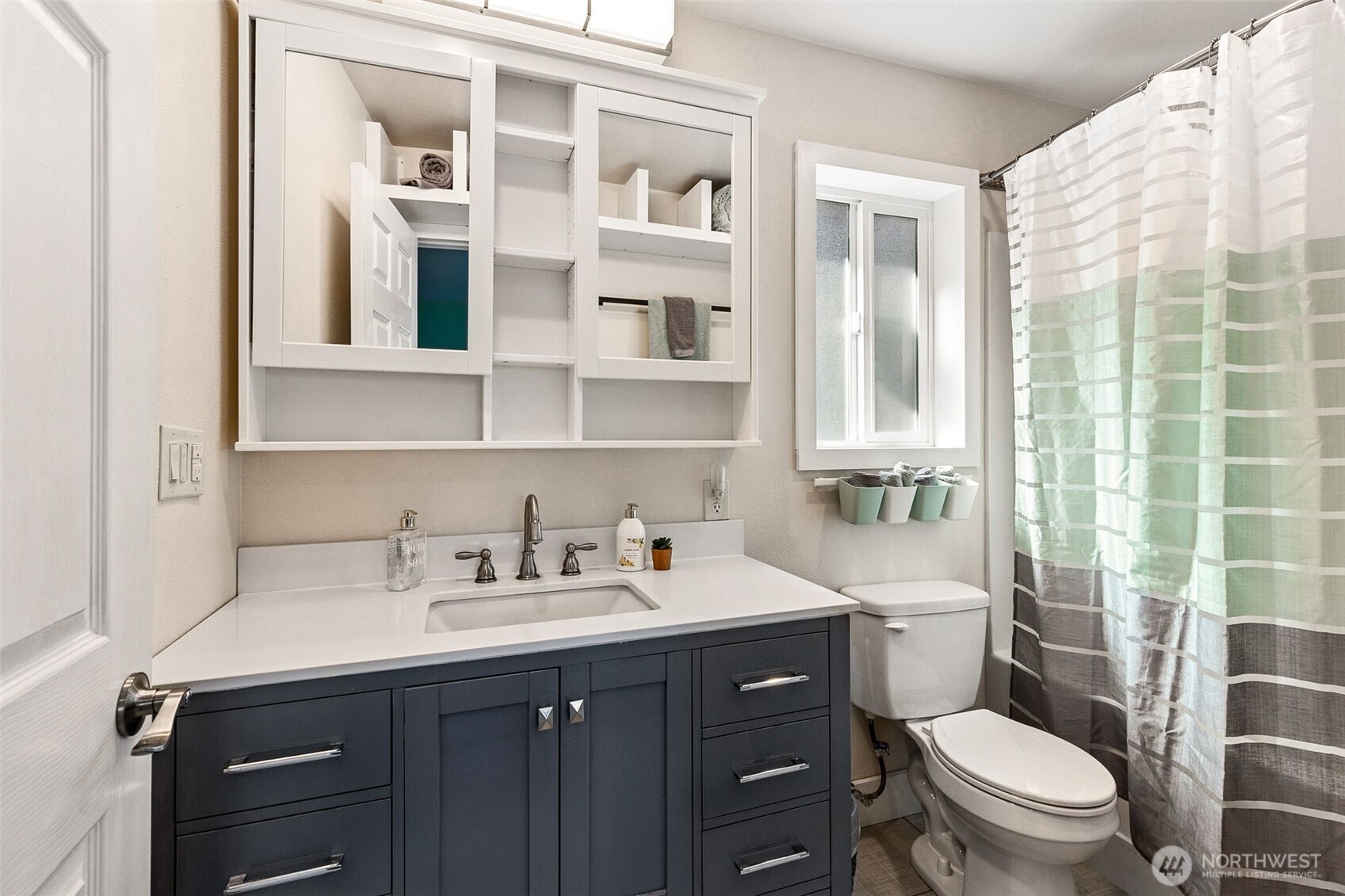 6103 Lackey Road Northwest Vaughn, WA 98394 - Photo 8 of 37 a bathroom with a sink a toilet and shower curtain