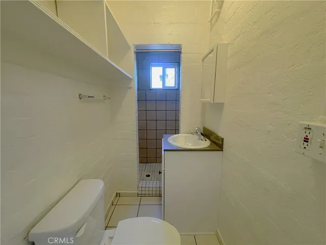 a bathroom with a toilet and a shower curtain