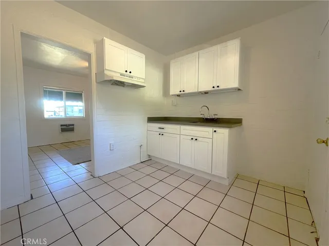 a view of a kitchen with white cabinets