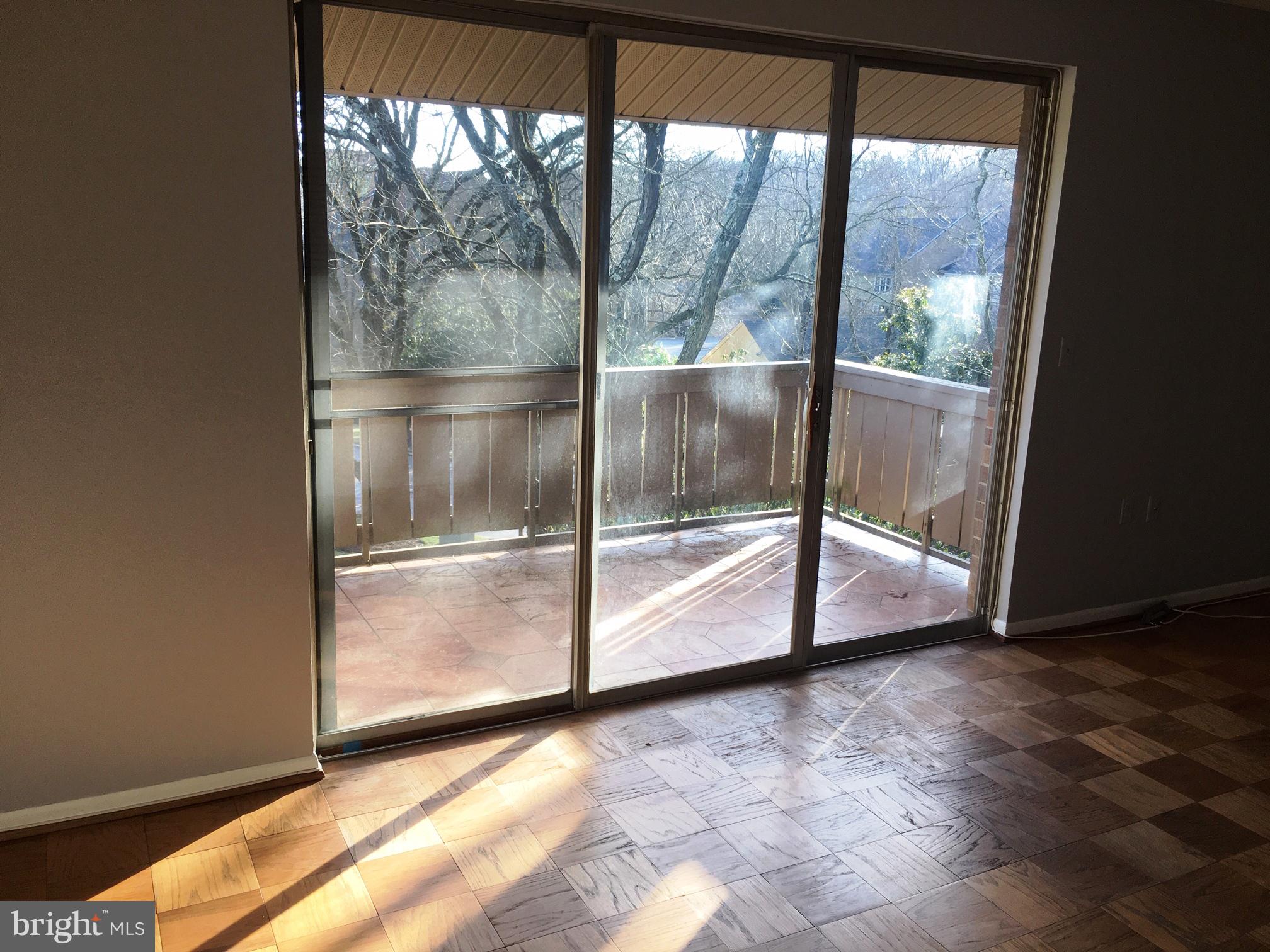 121 Cross Keys Road, Unit R121F Baltimore, MD 21210 - Photo 5 of 13 Dining Area leads to South-facing Deck (pool view)