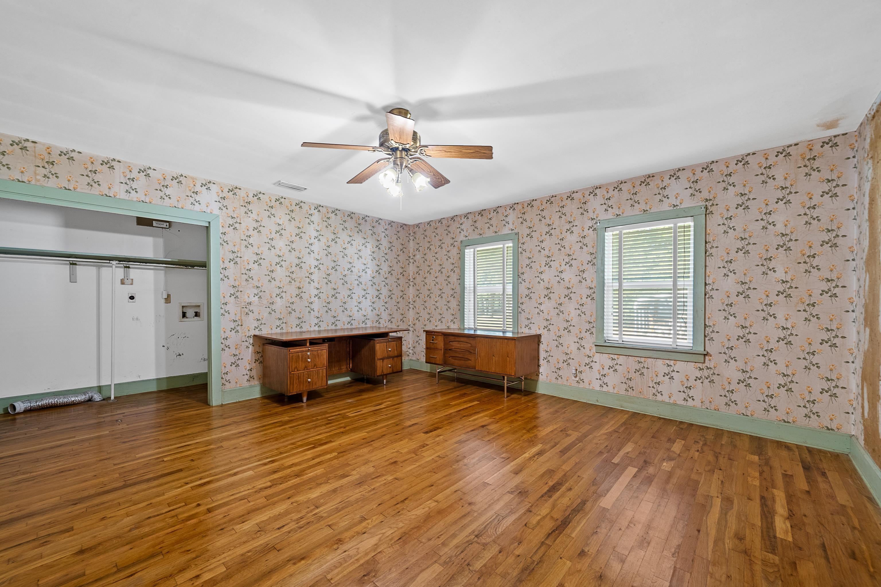 9350 Tompkins Road Stockton, AL 36579 - Photo 21 of 36 Unfurnished living room with hardwood / wood-style flooring and ceiling fan