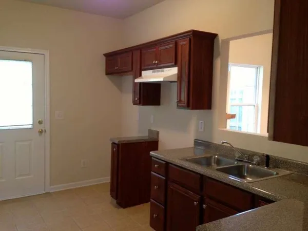 a kitchen with a sink and a mirror