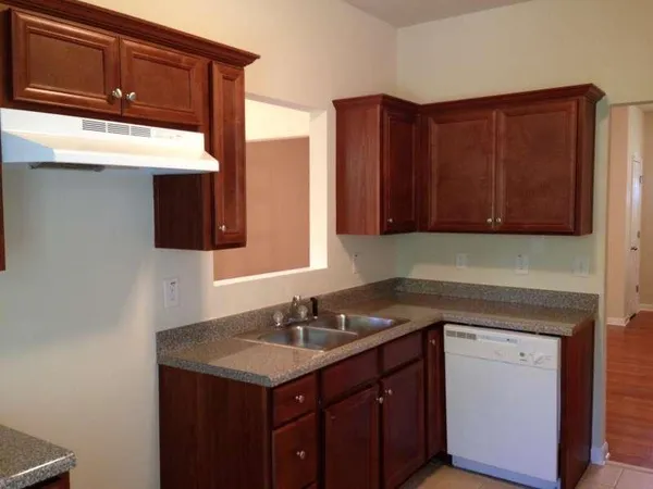 a kitchen with a sink cabinets and a microwave oven