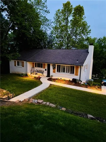 a front view of a house with a yard table and chairs