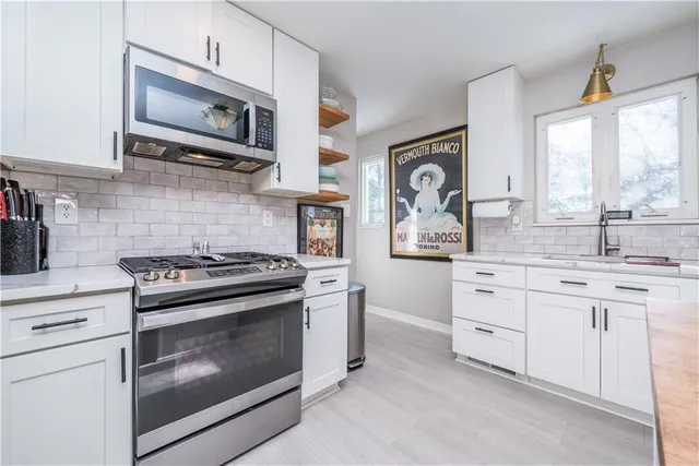 a kitchen with cabinets and wooden floor