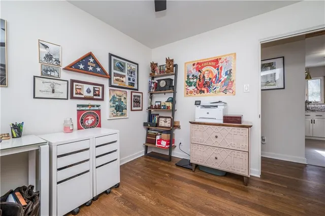 a view of a workspace with furniture and a window