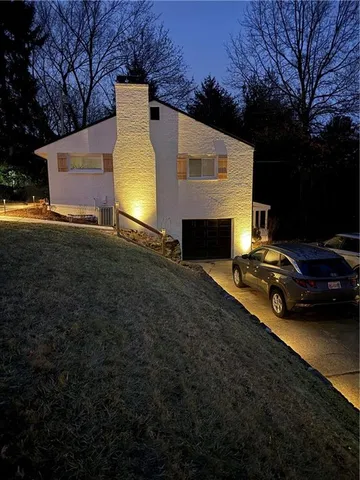 a view of a yard with car parked on the road