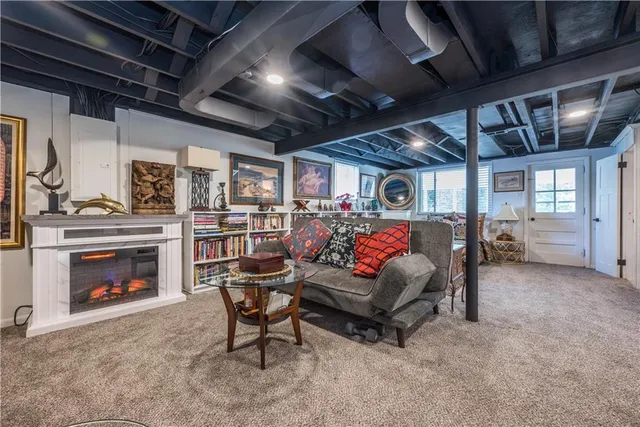 a living room with furniture and a clock