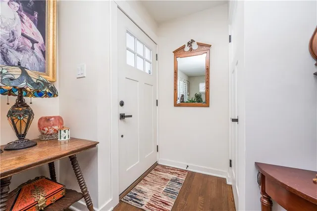 a living room with furniture fireplace and potted plant