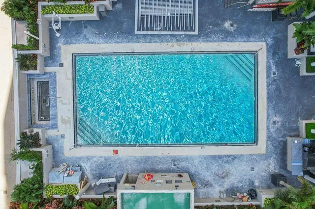 a view of a hallway with windows and brick walls