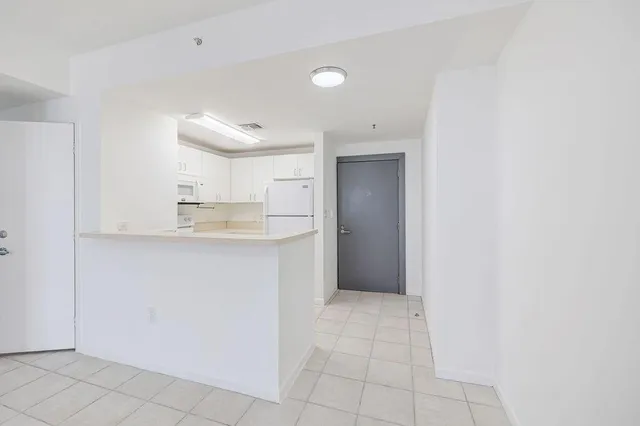 a view of kitchen cabinets and refrigerator