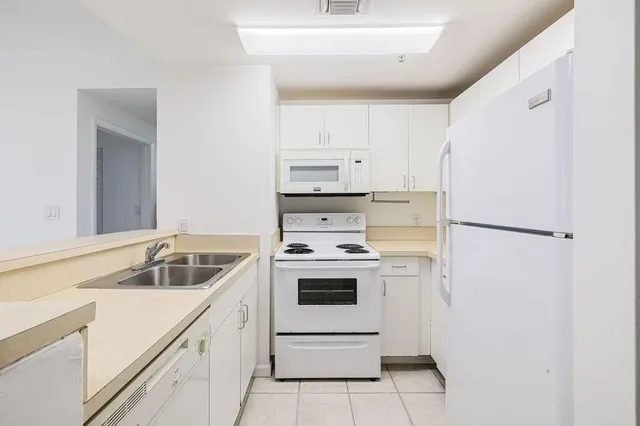 a kitchen with a sink a stove and refrigerator