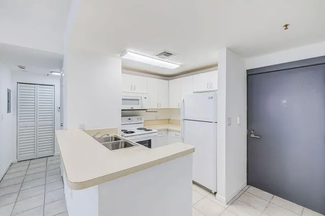 a kitchen with a white stove top oven and refrigerator