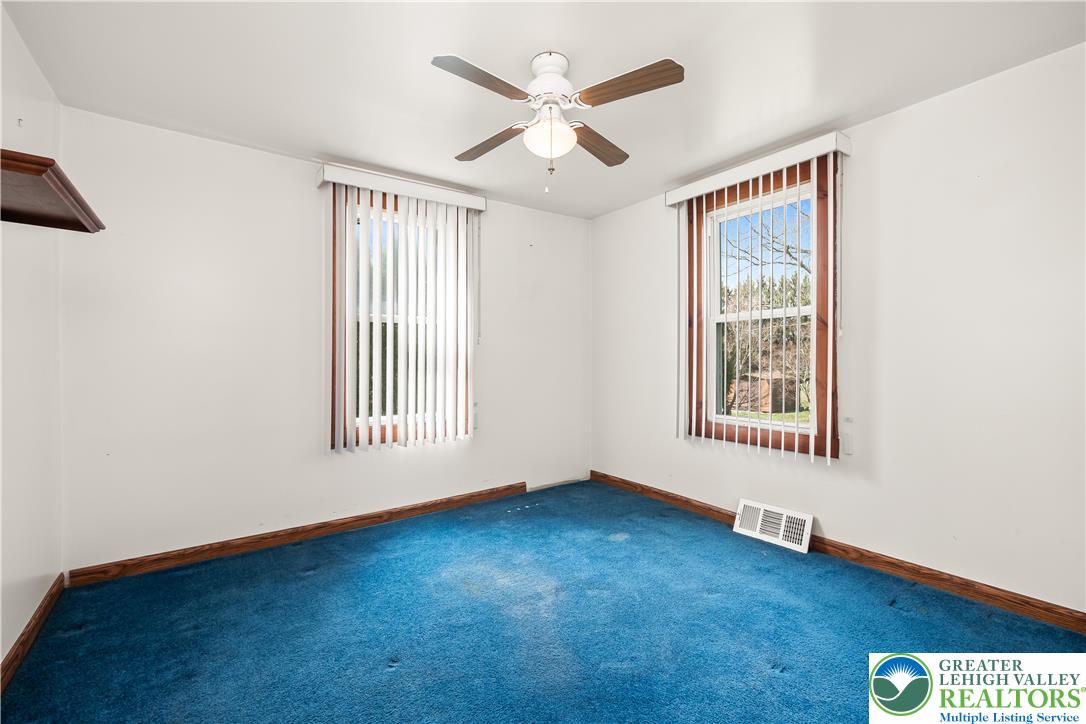 7309 Bell Gate Road Coopersburg, PA 18036 - Photo 30 of 58 an empty room with windows and ceiling fan