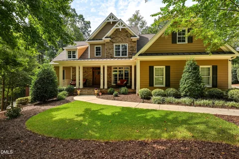 a front view of a house with swimming pool and porch