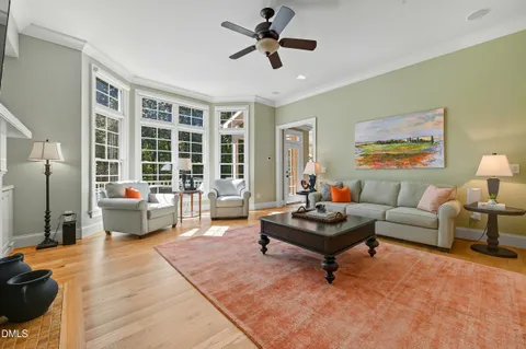 a living room with furniture a large window and a fireplace